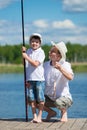 Dad and his son caught fish in a bait in the lake Royalty Free Stock Photo