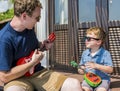 Dad and his sun with ukulele Royalty Free Stock Photo