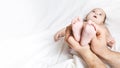 Dad is holding the baby`s tiny feet. Small baby feet on male hands close up. Happy family concept. Beautiful conceptual image of Royalty Free Stock Photo