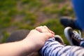 Dad is holding the hand of his son outdoors, parental love concept Royalty Free Stock Photo