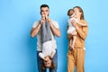 Dad holding his child upside down and kissing her feet