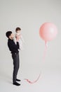 Father daughter moment watching a pink balloon on white background Royalty Free Stock Photo