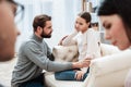 Dad holds daughter hand and try to talk.