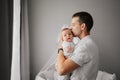 a dad holds his newborn son in his arms and kisses him. Royalty Free Stock Photo