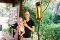 Dad holds a little boy in his arms while standing in the gazebo next to the inflatable digit 1