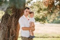 Dad hugging son outdoors in the park. The concept of summer holiday. father`s, baby`s day. Family spending time together on natu Royalty Free Stock Photo