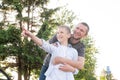 Dad hugs a happy boy standing near the car in the woods the bright sun. The concept of a family day Royalty Free Stock Photo