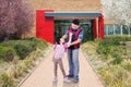 Dad and kid standing in front of the school Royalty Free Stock Photo