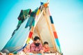 Dad with kids playing together in tent. Summer outdoor. Family playing together. Happy father with chidren, camping