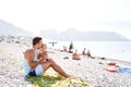 Dad kisses his little daughter while feeding on the beach Royalty Free Stock Photo