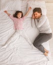 Dad and little girl sleeping together on bed Royalty Free Stock Photo