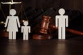 Dad and mom with child figures with judge gavel. Divorce by law concept Royalty Free Stock Photo