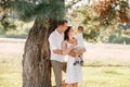 Dad, mom hugging son outdoors in the park. The concept of summer holiday. Mother`s, father`s, baby`s day. Family spending time Royalty Free Stock Photo