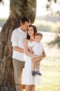 Dad, mom hugging son outdoors in the park. The concept of summer holiday. Mother`s, father`s, baby`s day. Family spending time Royalty Free Stock Photo