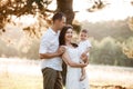 Dad, mom hugging son outdoors in the park. The concept of summer holiday. Mother`s, father`s, baby`s day. Family spending time Royalty Free Stock Photo