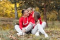 Dad, mom and little cute daughter having fun and playing in the autumn park. family concept, father`s, mother`s and baby`s day Royalty Free Stock Photo