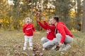 Dad, mom and little cute daughter having fun and playing in the autumn park. family concept, father`s, mother`s and baby`s day Royalty Free Stock Photo