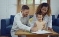 Dad, Mom and little daughter drawing with colorful pencils on paper happy smiling.Young family spend free time together in living Royalty Free Stock Photo