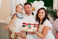dad and mom with little girlwith birthday cake with candles Royalty Free Stock Photo