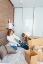 Dad mom and little son play in the bedroom with paper boxes Royalty Free Stock Photo