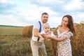 Dad, mom playing with their baby son in wheat field on sunset Royalty Free Stock Photo