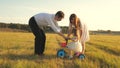 Dad and Mom teach daughter to ride a bike. Mother and father play with small child on lawn. kid learns to ride bicycle Royalty Free Stock Photo