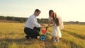 Dad and Mom teach daughter to ride a bike. Mother and father play with small child on lawn. kid learns to ride bicycle Royalty Free Stock Photo