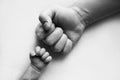 Dad and newborn boy son keep their hands in a fist, small and big fists. Royalty Free Stock Photo