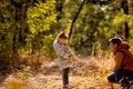 Dad playing with daughter, throw dry yellow fallen leaves. walks in autumn Park Royalty Free Stock Photo