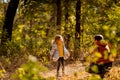 Dad playing with daughter, throw dry yellow fallen leaves. walks in autumn Park Royalty Free Stock Photo