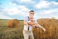 Dad playing with his baby son in wheat field on sunset Royalty Free Stock Photo