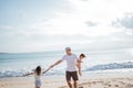 Dad playing with his daughter on the beach having fun together Royalty Free Stock Photo
