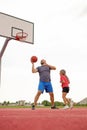 Dad plays basketball with a child, throwing a ball into the basket Royalty Free Stock Photo