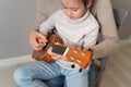 Dad plays the guitar with his daughter. The child learns to play a musical instrument with a tutor. Musical duet of a Royalty Free Stock Photo