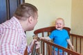 Dad plays guitar to console his crying son Royalty Free Stock Photo