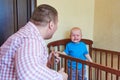 Dad plays guitar to console his crying son Royalty Free Stock Photo