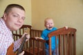 Dad plays guitar to console his crying son Royalty Free Stock Photo