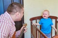 Dad plays guitar to console his crying son Royalty Free Stock Photo