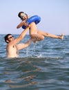 Dad plays with her daughter and the little girl makes splashing