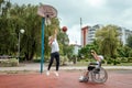 Dad plays with his disabled son on the sports ground. Concept wheelchair, disabled person, fulfilling life, father and son,