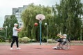 Dad plays with his disabled son on the sports ground. Concept wheelchair, disabled person, fulfilling life, father and son,