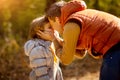 Dad plays and hugs with daughter in autumn Park. nature walks Royalty Free Stock Photo