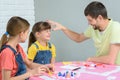 Dad punches a girl who lost in a board game Royalty Free Stock Photo