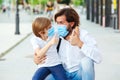 Dad and schoolboy wearing face mask. Schoolboy is ready go to school. Coronavirus pandemic. Father with child in medical mask at