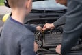 Dad shows his little happy son how the car works Royalty Free Stock Photo