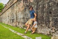 Dad and son on background of Fort Cornwallis in Georgetown, Penang, is a star fort built by the British East India Company in the Royalty Free Stock Photo