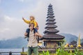 Dad and son in the background of Pura Ulun Danu Bratan, Bali. Hindu temple surrounded by flowers on Bratan lake, Bali Royalty Free Stock Photo