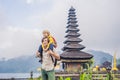 Dad and son in the background of Pura Ulun Danu Bratan, Bali. Hindu temple surrounded by flowers on Bratan lake, Bali Royalty Free Stock Photo