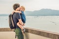 Dad and son in the background of Tropical beach landscape panorama. Beautiful turquoise ocean waives with boats and Royalty Free Stock Photo