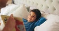 Dad, son and bed with book, story and reading together with learning, knowledge and happy in family home. Father, male Royalty Free Stock Photo